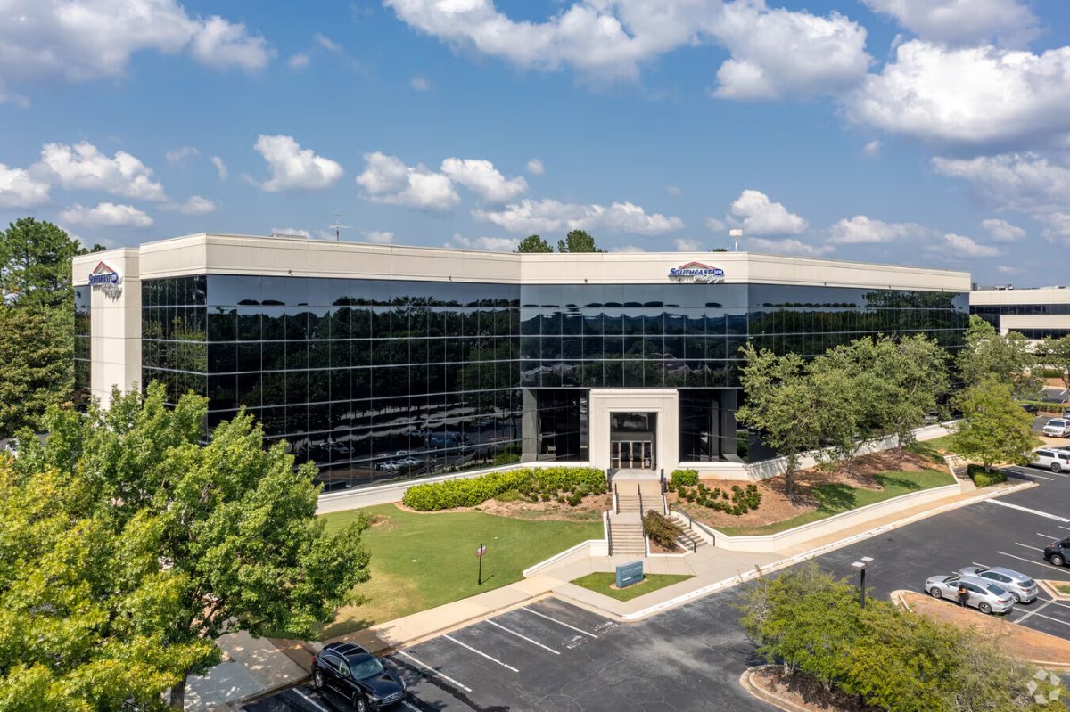 The office building in Duluth, Georgia, with a glass facade and landscaped entrance
